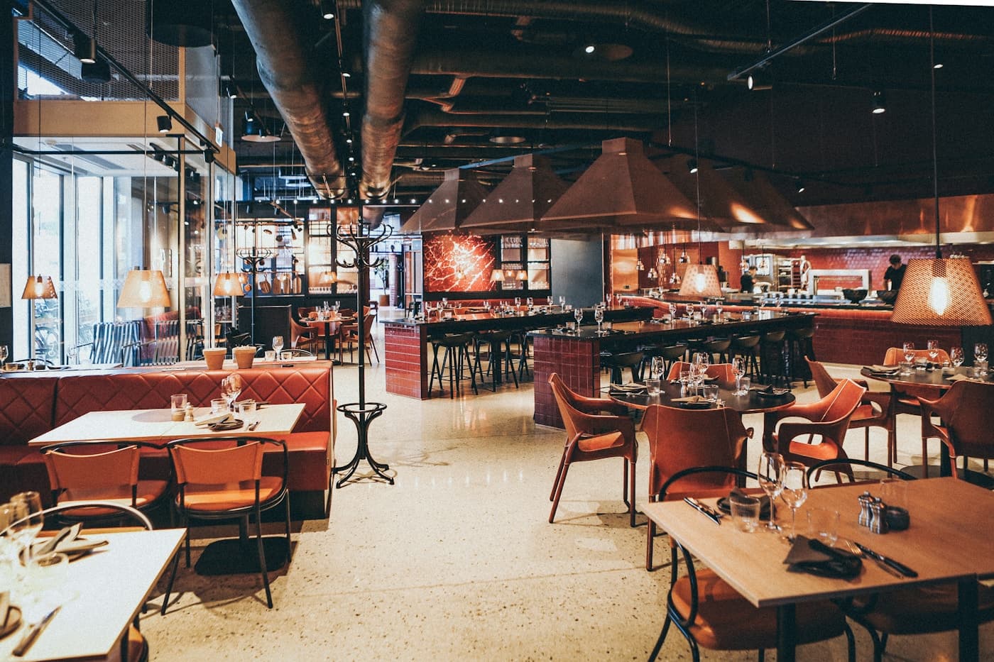 Un restaurante cálido, con mesas listas para recibir a sus clientes